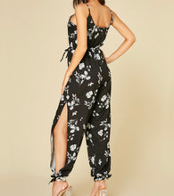 Load image into Gallery viewer, Black print jumpsuit with  open legs and pockets
