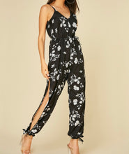 Load image into Gallery viewer, Black print jumpsuit with  open legs and pockets
