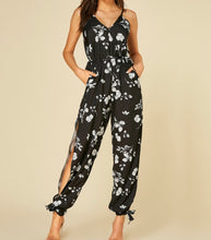 Load image into Gallery viewer, Black print jumpsuit with  open legs and pockets
